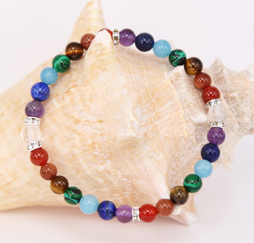 Un fin bracelet multicolore, pierres Arc-en-ciel, agrémenté de perles plates métal argenté ornées de strass. À la fois joyeux, élégant, festif.