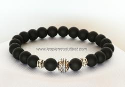 Un bracelet bouddhique très masculin, sous le signe de la sérénité bienveillante. L'aspect noir mat velouté des perles d'Onyx font penser à la souplesse discrète des grands fauves, efficaces et silencieux.