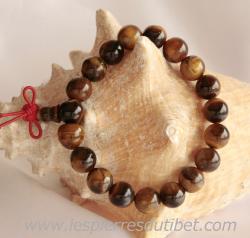 Ce mala de poignet traditionnel confectionné de perles de pierres Oeil de tigre aux vertus intéressantes, en plus d'être un objet de méditation en pleine conscience