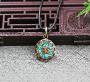 Ce charmant petit médaillon est orné d’un semis mosaïque de pierres Turquoise. Dans la Tradition tibétaine, la Turquoise apporte richesse matérielle et spirituelle.